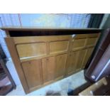 A large early 20th century oak wall closed bookcase or wall cupboard. With two large panelled doors