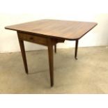 A late victorian mahogany Pembroke table with single drawer on tapered legs and castors. W:105cm x
