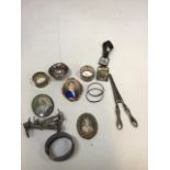 A silver napkin ring, two childs bracelets, silver handled glove stretchers, miniatures and other