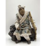 A large pottery figure of an Asian man with pipe. With high firing glazing, with two character marks