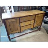 An early 20th century oak sideboard with attractive part painted decoration. With metal handles,