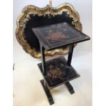 A lacquered two tier oriental style side table decorated with birds and flowers also with a papier-