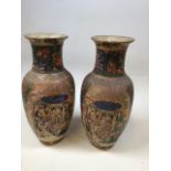 A pair of decorative Oriental vases depicting cherry blossom and a garden scene. Red markings to
