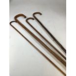 A bamboo cane with metal tip with three others. Cane A/F