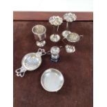 Assortment of silver items, including miniature trophies, tea strainer and posy vases. Silver weight