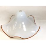 A large vintage milk glass Pendant Light shaped as a hat with orange fluted edge. Probably Italian