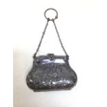 A silver hallmarked purse decorated with cherubs - silk lined. Weight 53gm