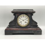 A black slate Victorian mantel clock with a 4-inch white dial, moon hands, two train French movement