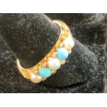 An 18ct pearl and turquoise and diamond ring.