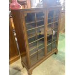 A small 20th century glazed book case with three adjustable height shelves. With working key. W:84cm