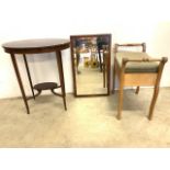 An ellipse shaped inlaid Edwardian table with lower shelf, a piano stool also with a rosewood