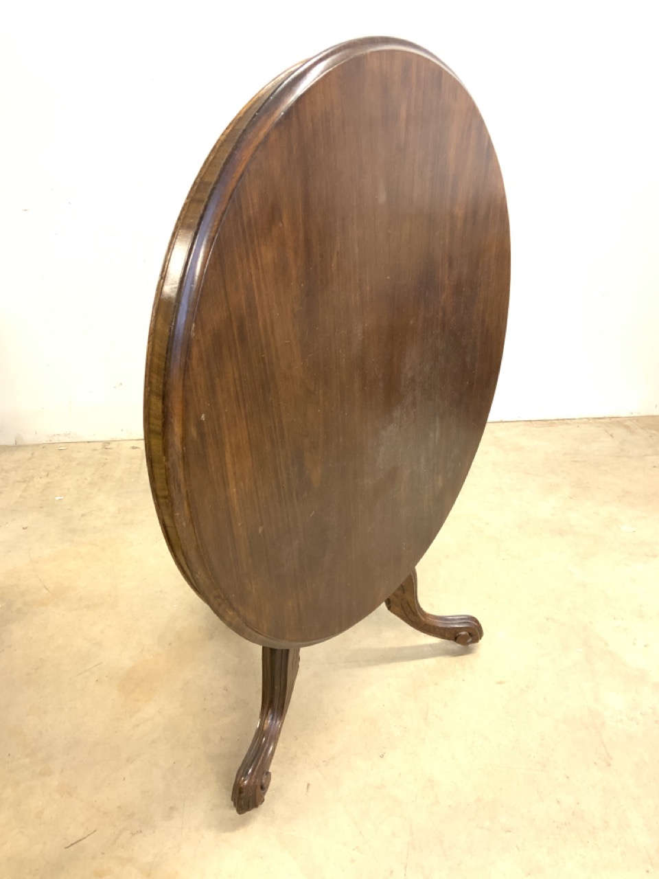 A circular breakfast tilt top table on turned column and tripod base with metal castors. W:104cm x - Bild 3 aus 3