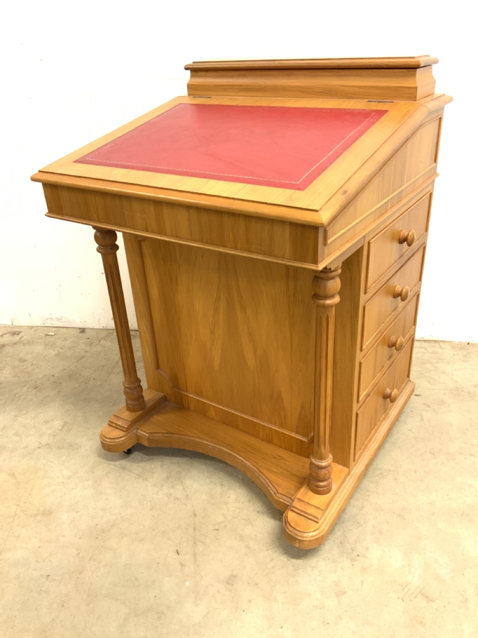 A modern good quality yew wood Davenport with red leather inset writing slope to internal storage
