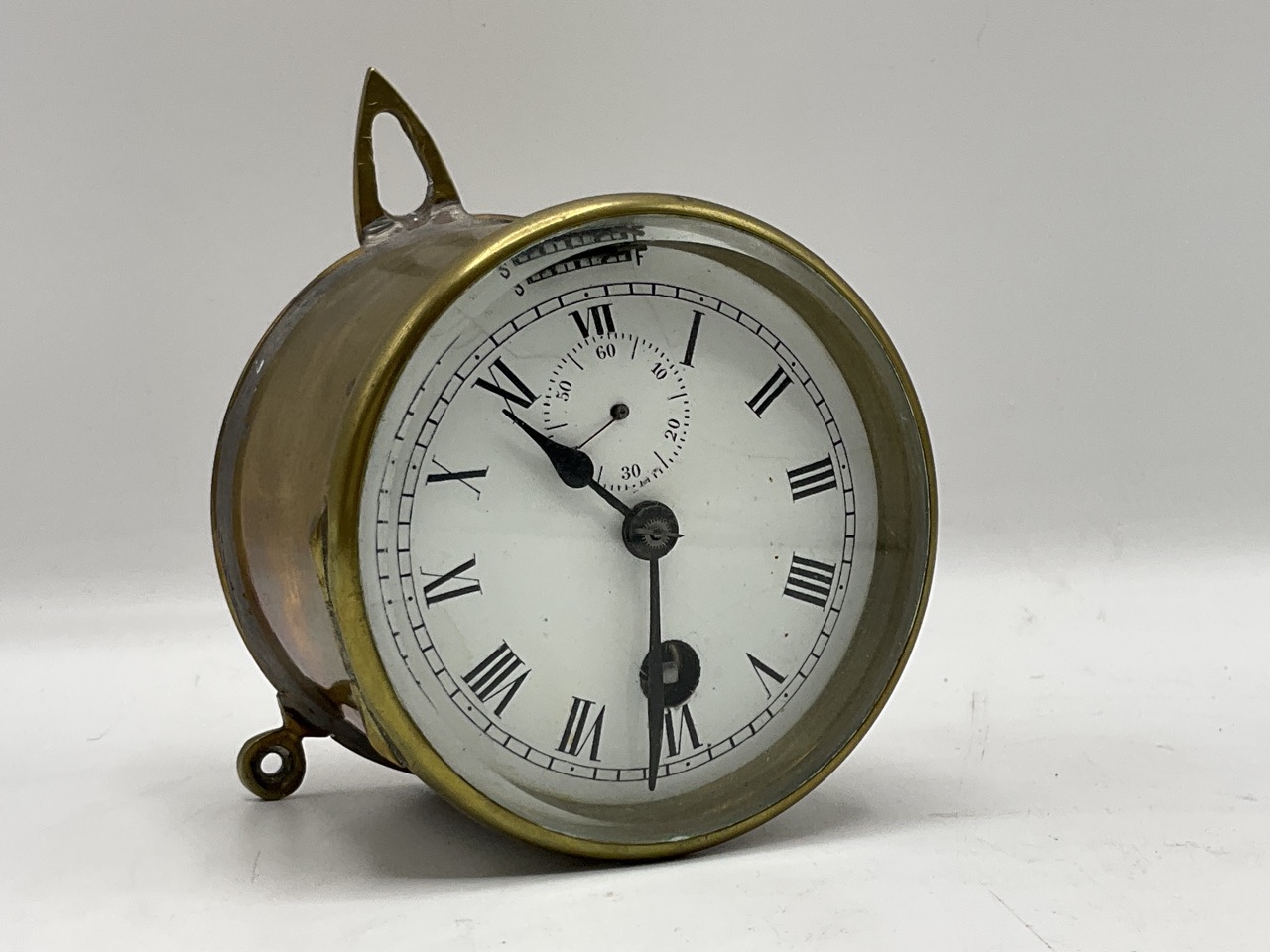 A small single train clock with 3 ½ inch white dial containing a subsidiary seconds dial. With fast