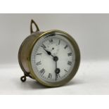 A small single train clock with 3 ½ inch white dial containing a subsidiary seconds dial. With fast