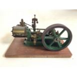 A Stuart Turner small model engine. On mounted on board with original paintwork. W:30cm x D:20cm x