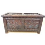 A small eight panel coffer with tribal decorative carvings and camphour wood interior. Each panel