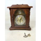 A 20th century oak mantel clock, Emperor Tempus fugit. With pendulum and key. H:40cm