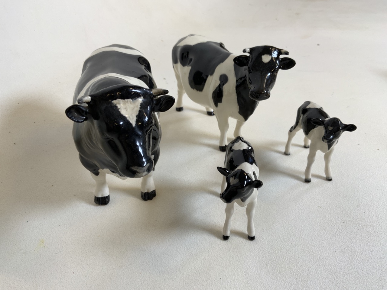 Beswick Cattle family group of bull, Cow and 2 calfs. A Champion Coddington Hilt Bar bull marked