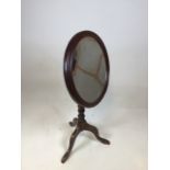 An antique mirror on tripod stand H:74cm