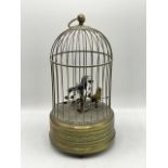 Early 20th century brass musical automaton bird cage. Two mechanical birds set upon leaves within