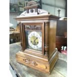 A German Junghams bracket clock with bevelled glass and pendulum.