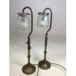 A near pair of copper and brass swan neck architectural style lamps with opaque glass shades H:51cm