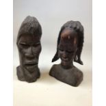African wooden heads. A female H:34cm and a male mask H:35cm