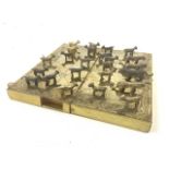 A folding metal bound travel game of lambs and lions, 4 brass lions and 20 lambs.