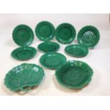 A set of Wedgwood green majolica sunflower amid basket weave plates - eight in total - with two leaf