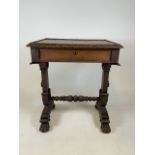 A late 19th early 20th century table with compartmented drawer on carved lion paw feet on castors
