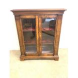 A Victorian walnut veneered glazed bookcase, with two internal shelves. With lockable doors and