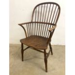 A 19th century English bow back elm seated Windsor chair. Slight splits to seat.