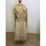 A full length waisted cream mink (?) ladies coat. Cross chest measurement 40 inches. Length from top