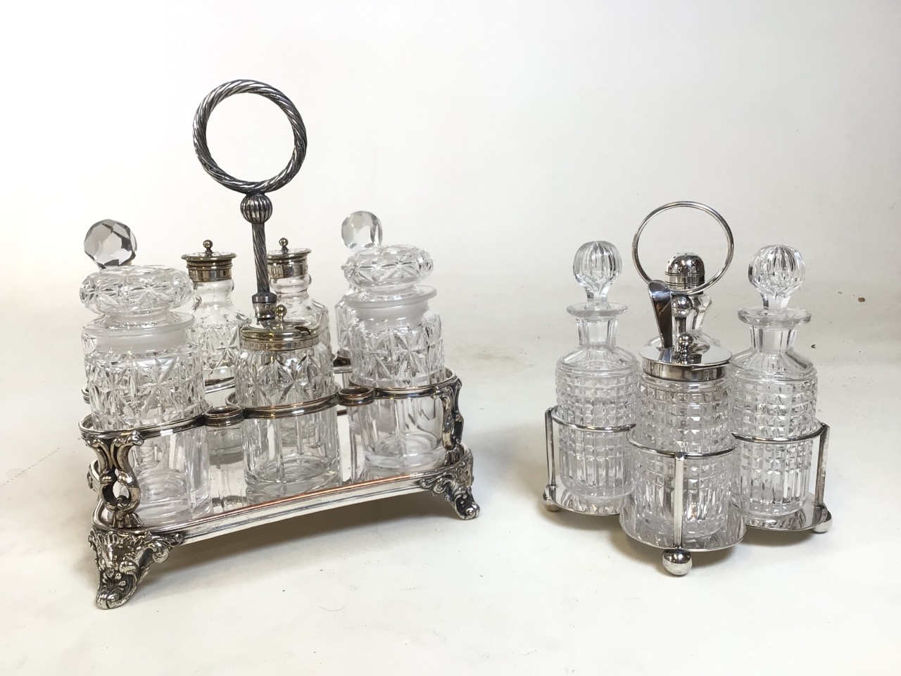 Two silver plate and cut glass cruet sets. A 7 and 4 piece condiment caddy respectively. Good