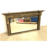 A Victorian overmantle mirror, gilt painted gesso on wood frame with dark wood mount. Later