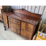 A serpentine fronted walnut veneered sideboard with three drawers flanked by cupboards W:154cm x D: