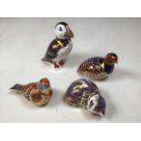 Four Royal Crown Derby paperweight. A puffin, a cat, a pheasant and one other. With gold stoppers,
