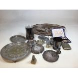 A quantity of silver plated items also with a silver topped glass bottle