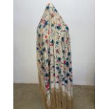 A vintage silk hand embroidered piano shawl with a cream deep knotted silk fringe. Ornately