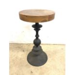 A small occasional table of contemporary design with turned metal base and chunky wood top.