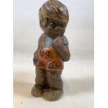 A Swedish pottery figure of a young child, stamped Sweden underneath. H:24.5cm