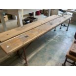 Two long pine benches with metal folding legs and support stretcher. Each bench with breather holes.