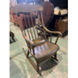 A Vintage spindle back rocking chair with scroll arms H:40cm