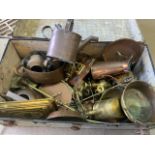 A large collection of brass and copper in vintage metal bound suitcase suitcase.