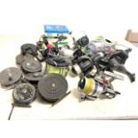 A large collection of metal fishing reels, Intrepid, Beaudex, Shakespeare, Daiwa, Aurora etc.