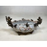 a decorative ceramic bowl on bronzed metal feet with bronzed metal cherubs and birds W:43cm x H: