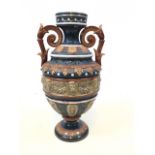 A decorative pottery two handled vase with lion mask and leaf decoration. Impressed mark to base.