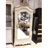 A french painted armoire with large shaped and bevelled mirror door to internal hanging space drawer