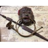 A wooden ethnographical mask, staff and a horn